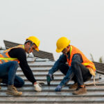 Roofers working to repair roof