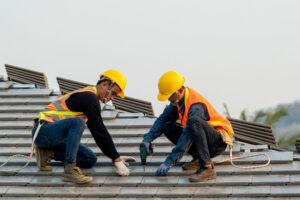 Roofers working to repair roof