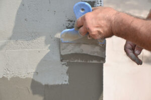 Worker preparing house for stucco installation